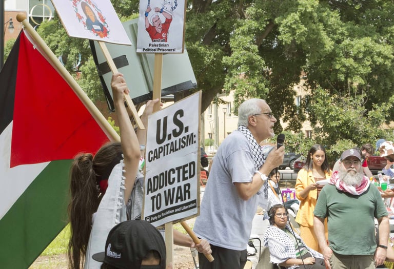 Burhan Ghanayem speaks passionately to a crowd at a protest
