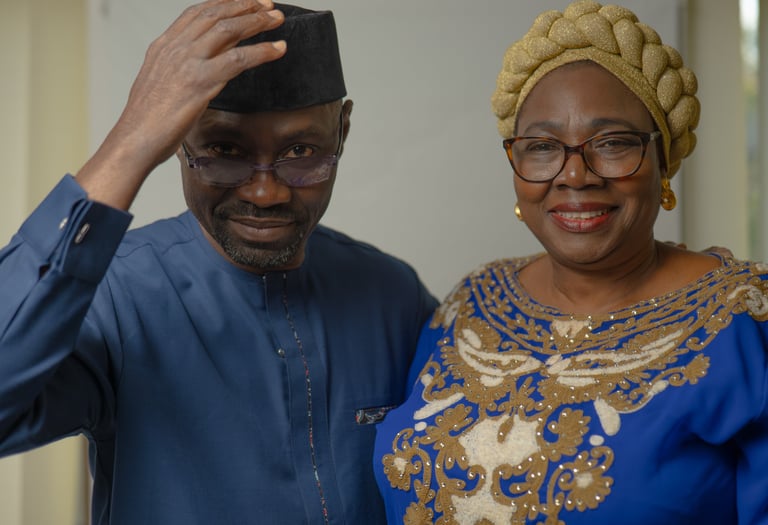 Older Nigerian couple dressed in elegant traditional attire, cultural portraits