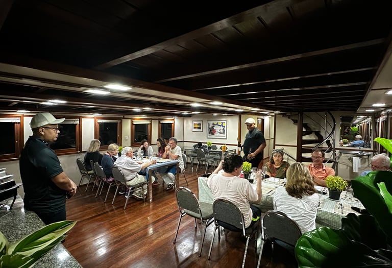 a group of people sitting at a table with food
