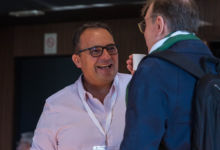 a man in a pink shirt and a man in a blue jacket