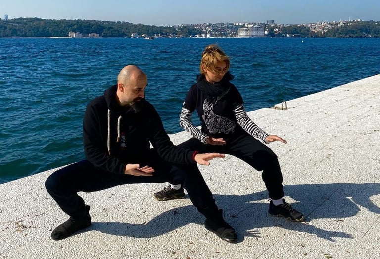 Ismet Himmet and Mine Şilliler practicing Tai Ji stances on the Bosphorus shore in Istanbul.