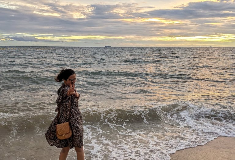 Riya, a human copywriter posing at the beach
