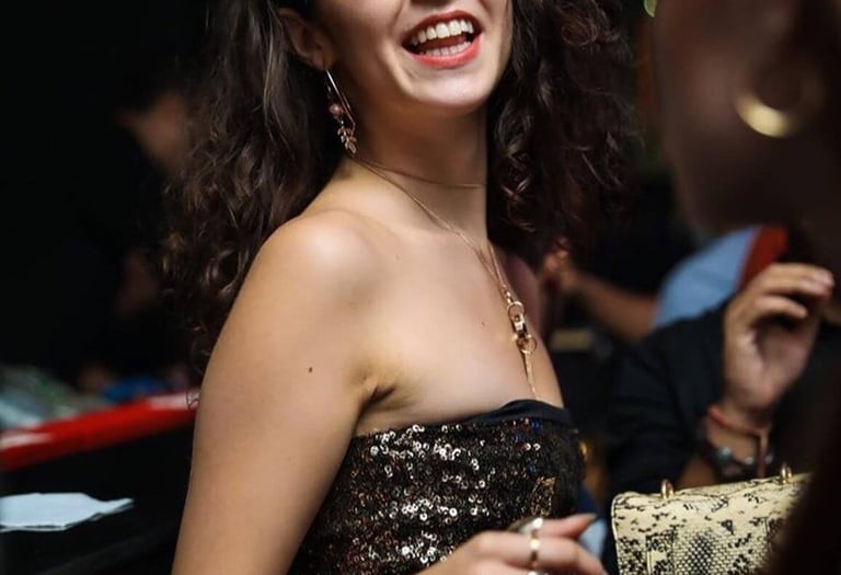 a woman in a sequinous top and jeans