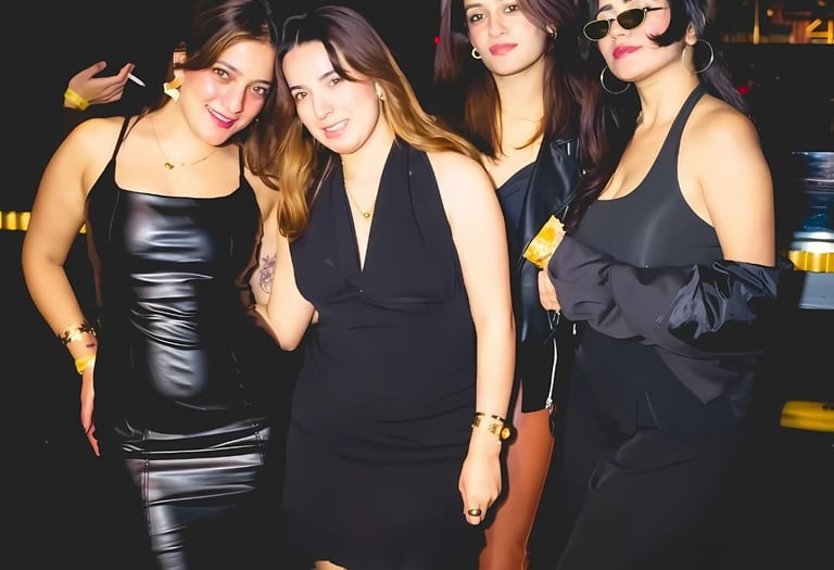a group of women in black dresses standing in a row