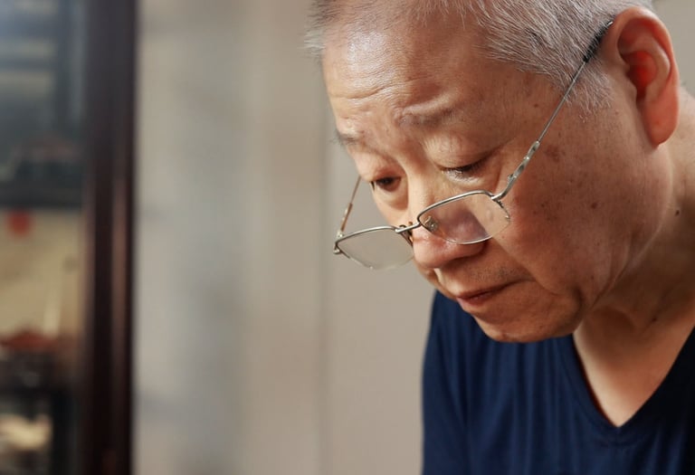Artisan Kuai Liangrong crafting a teapot