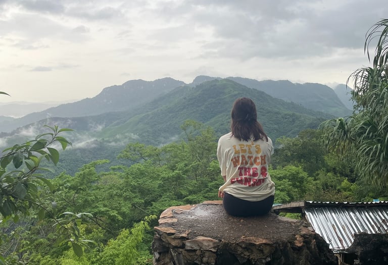 Girl on mountain watching the view at Ngoi