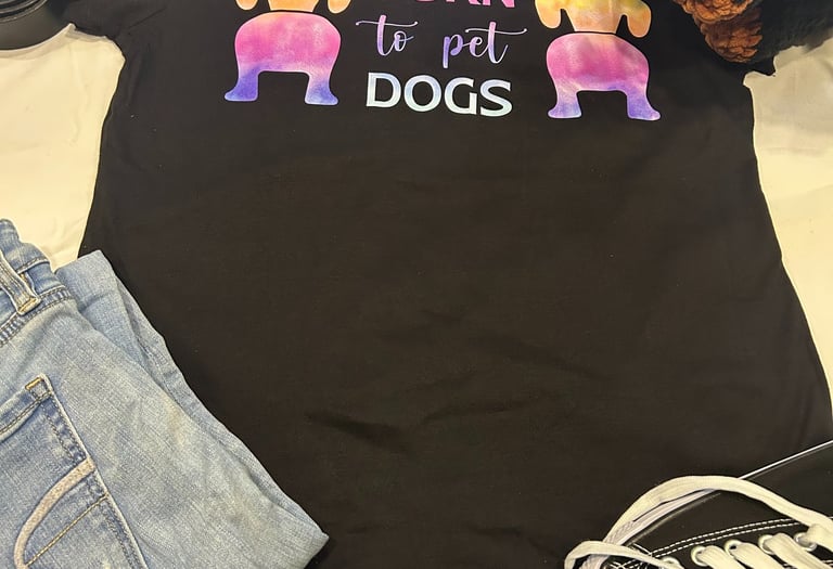 a tshirt that says "born to pet dogs" paired with a belt and jeans along with a stuffed rottweiler