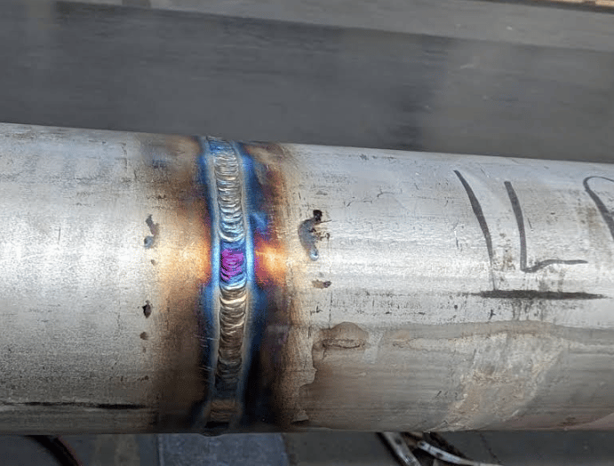 a metal pipe pipe with a blue flame on it