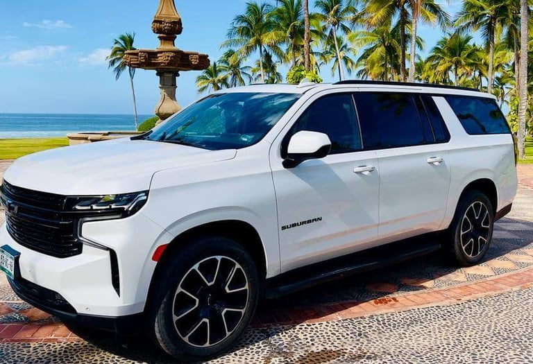 a white suv parked in front of a fountain