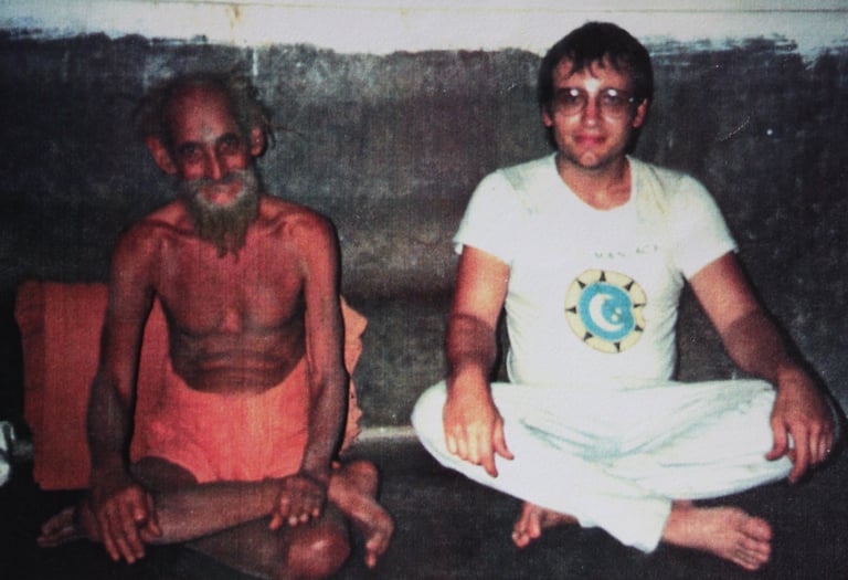 a man sitting on the floor with a beardless man
