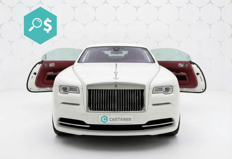 White Rolls-Royce Wraith luxury coupe with open suicide doors and red leather interior in a showroom.