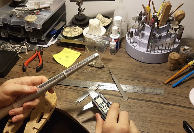 a person holding a ruler and measuring ruler