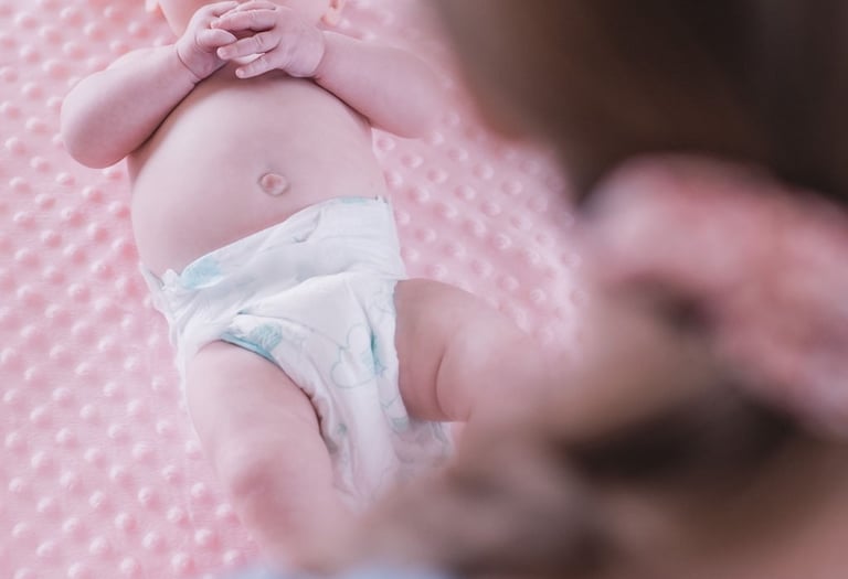 Baby lying on a pink blanket during a Rock & Roll Baby massage class in Radwinter near Saffron Walden