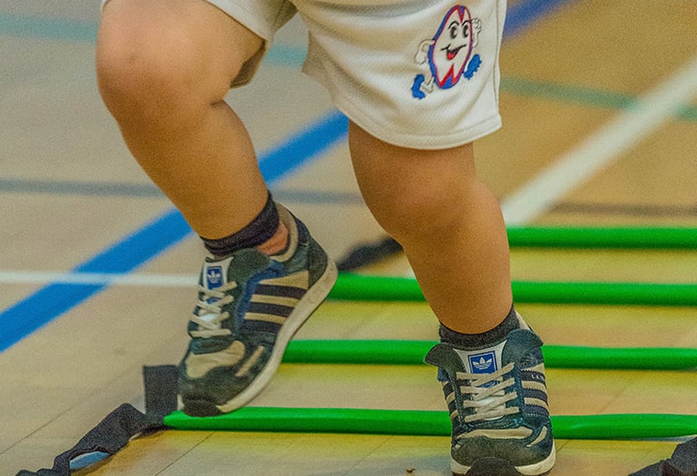 Toddler taking part in Ruggerbugs sports class in Saffron Walden indoor hall