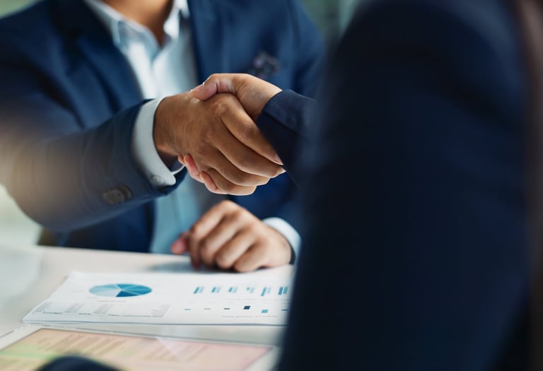 Two businesspeople shake hands after reaching an agreement