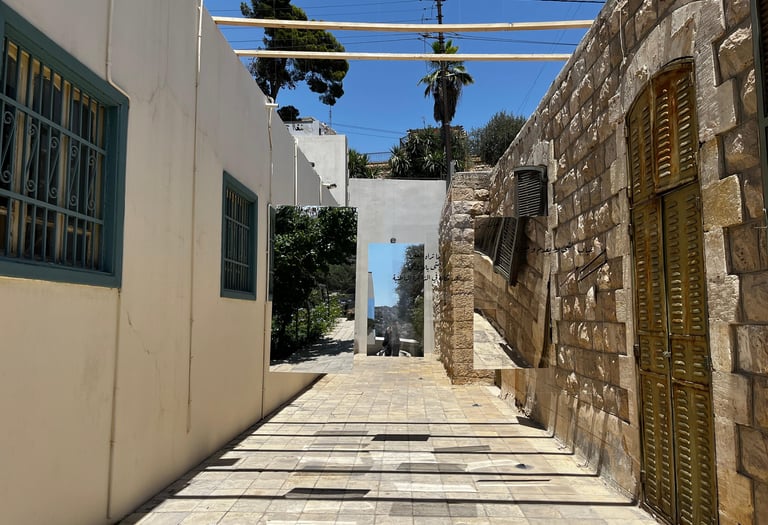 Mirrored art installation in a stone alleyway reflecting an outdoor scenery luminous space