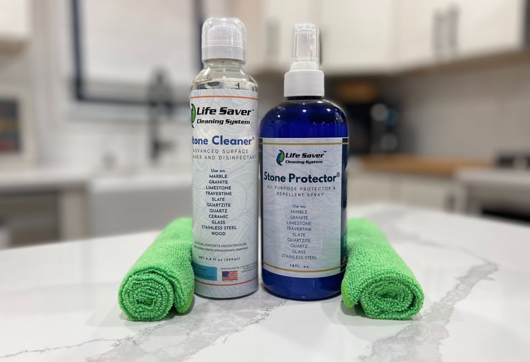 Life Saver Stone Cleaner and Stone Protector bottles with green microfiber cloths on a marble countertop.