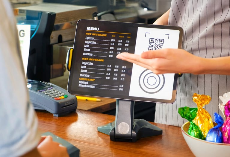 Tablet POS screen showing menu and QR code on café counter. Turn tablets into kiosk menus.