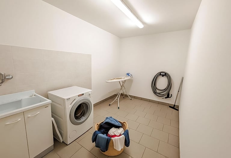 a laundry room with a washing machine and a laundry basket