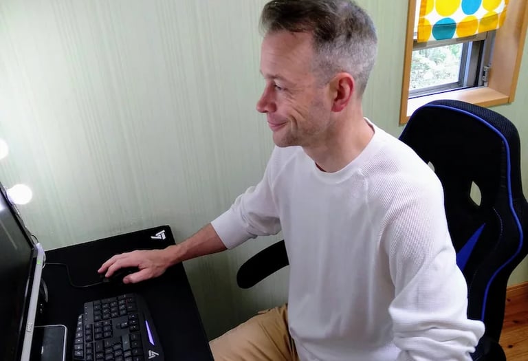 man teaching online student