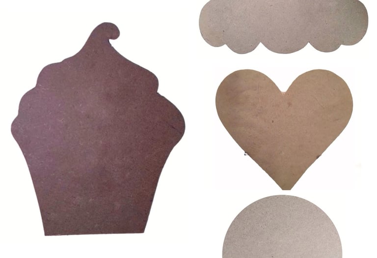a cupcake cut out of cardboard with a heart shaped cookie
