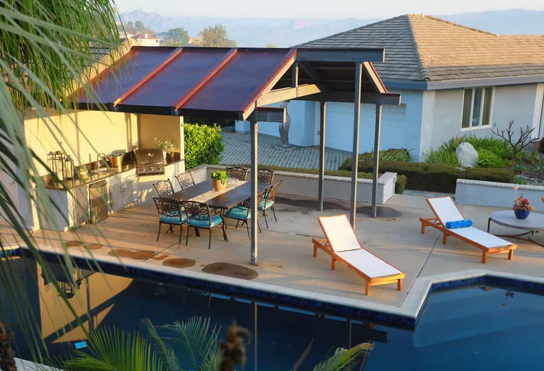 a pool with lounge chairs and a patio table