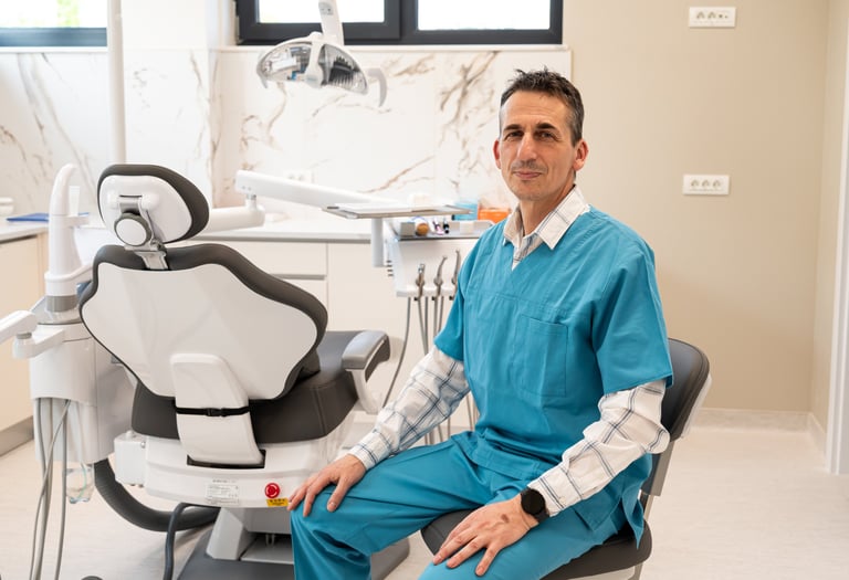a man in a blue scrub suit sitting in a chair