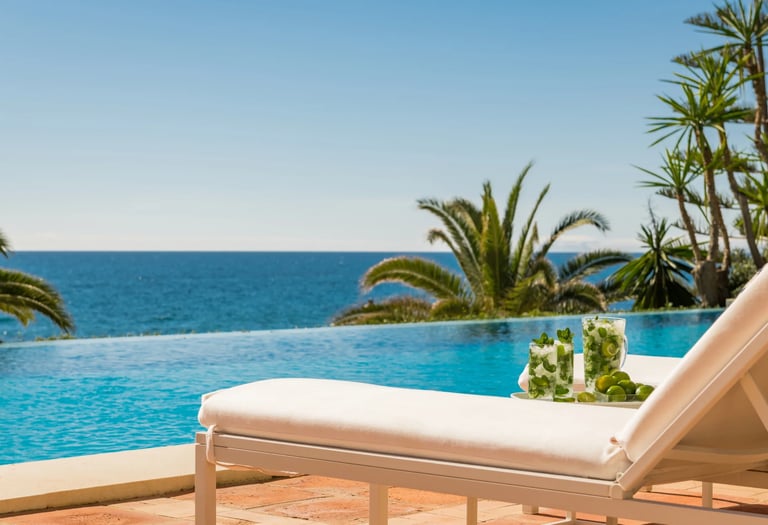 Infinity pool with sun lounger and panoramic sea views