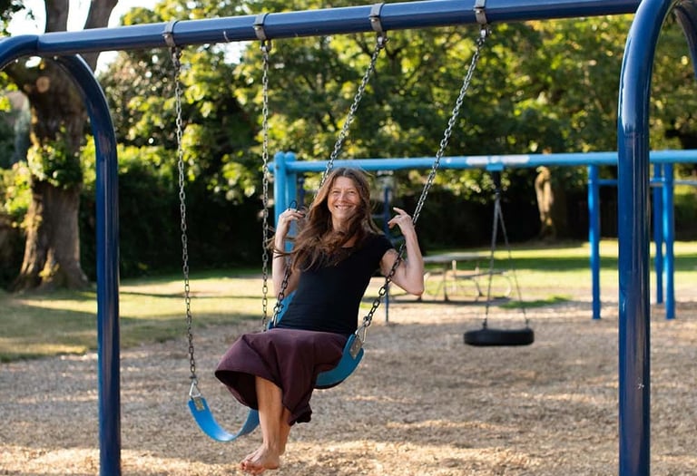 Tina Lilly, MS, LPC at play on a swing set