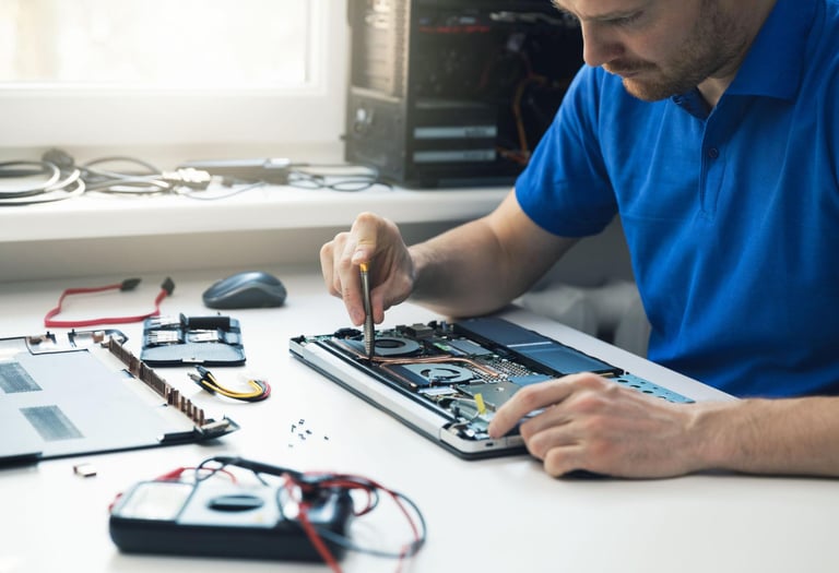 Laptop repair technician working on computer in Tampa Bay