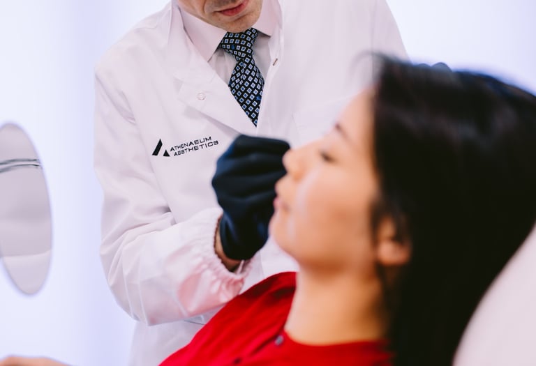 Dr Matthaios Souchlakis performing facial assessment before injectable treatment