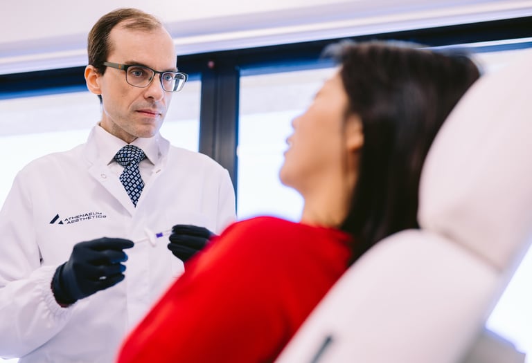 Dr Matthaios Souchlakis performing personalized patient consultation at Athenaeum Aesthetics