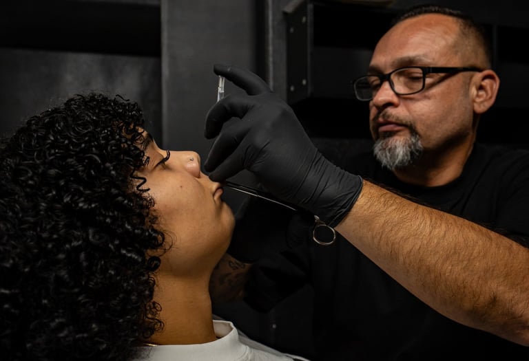 Matt doing a medusa piercing on a client