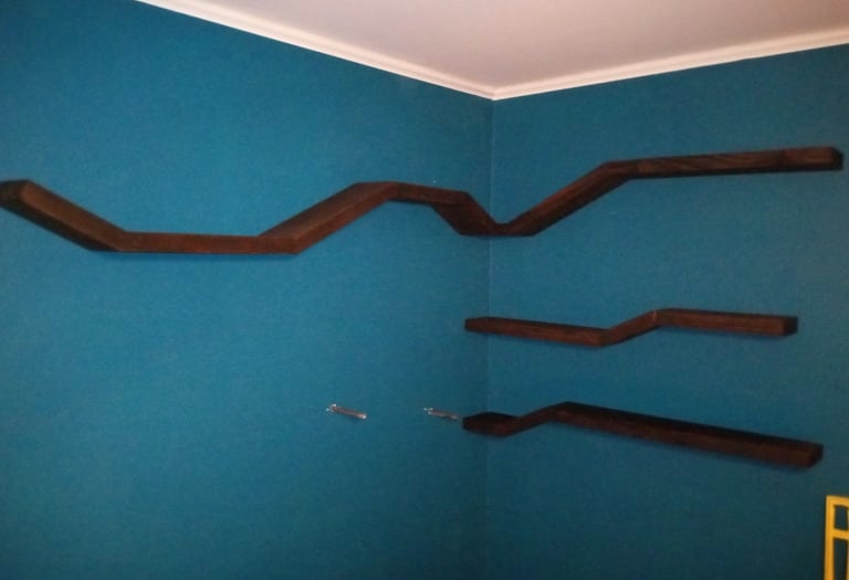 Four floating shelves mounted on wall