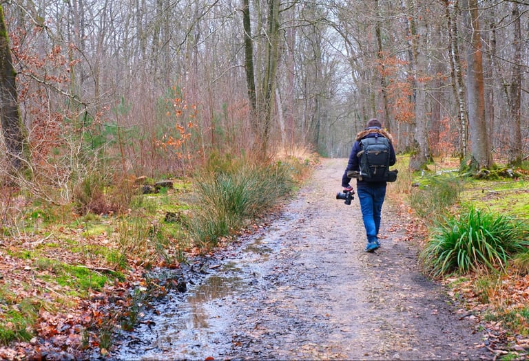 a man walking down a path with a backpack on his back
