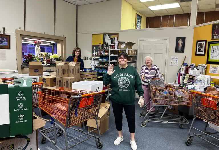 A group of happy volunteers working in the food pantry