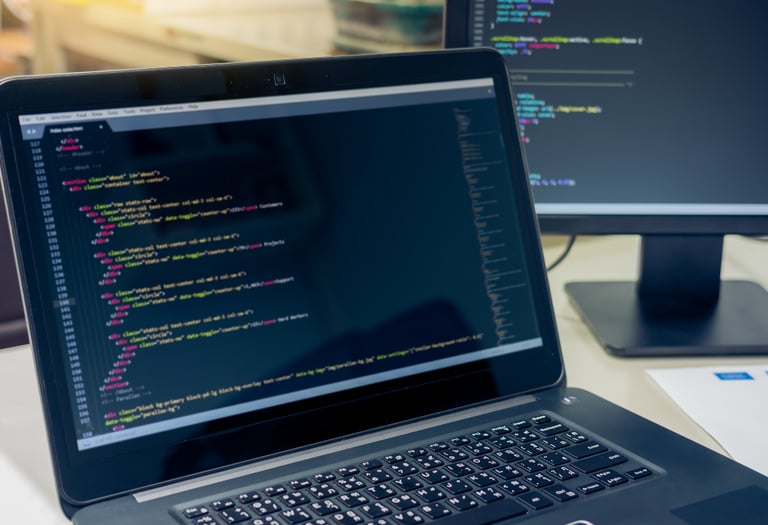 a laptop displaying HTML code