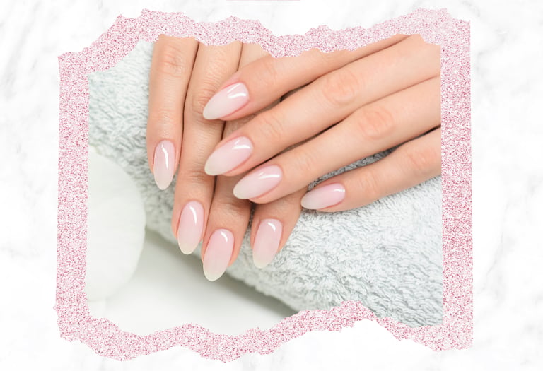 Elegant almond-shaped ombre french manicure on a light blue towel backdrop.