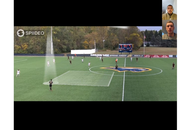 Coach Loic Baures doing film review with a youth athlete