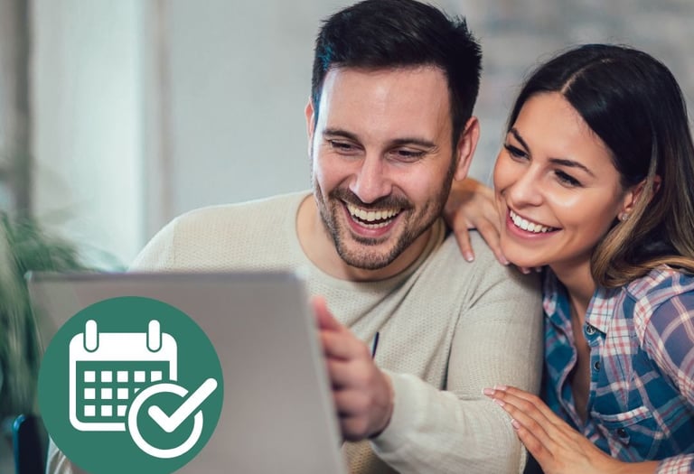 a man and woman looking at a laptop computer screen