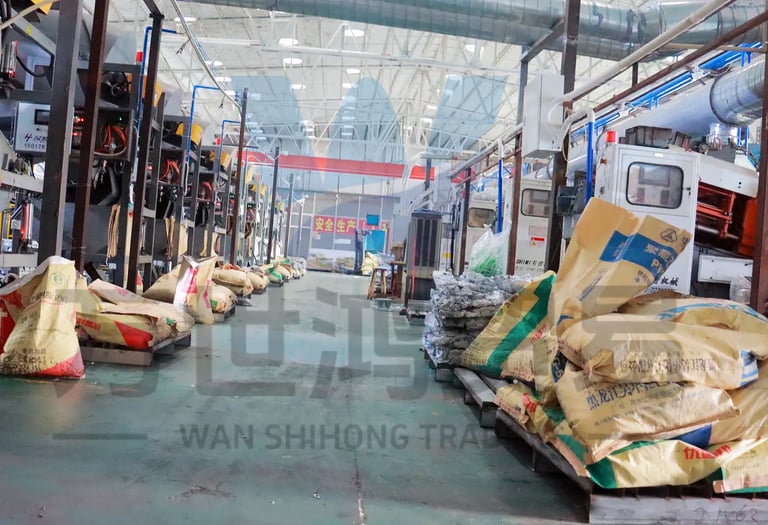 In the workshop of the bag and luggage accessories factory, rows of machines and raw materials for p