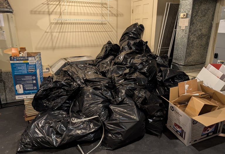 pile of trash bags and cardboard boxes