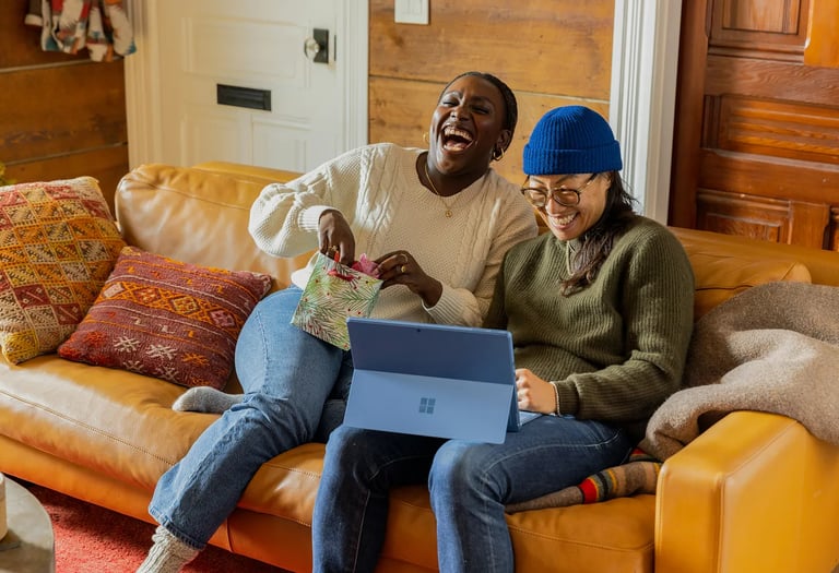 a queer couple sitting on a couch in a living room