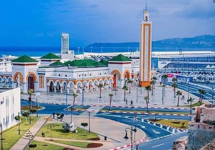 morocco tangier a large white building with a clock tower in the background