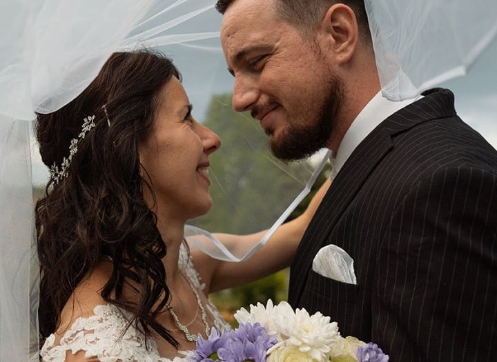 Bride and groom sharing a romantic moment during a wedding photoshoot in Preston Park, Brighton.