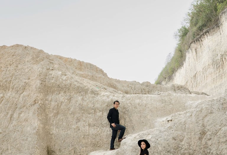Dramatic prewedding portrait at limestone cliff of Melasti Beach Bali
