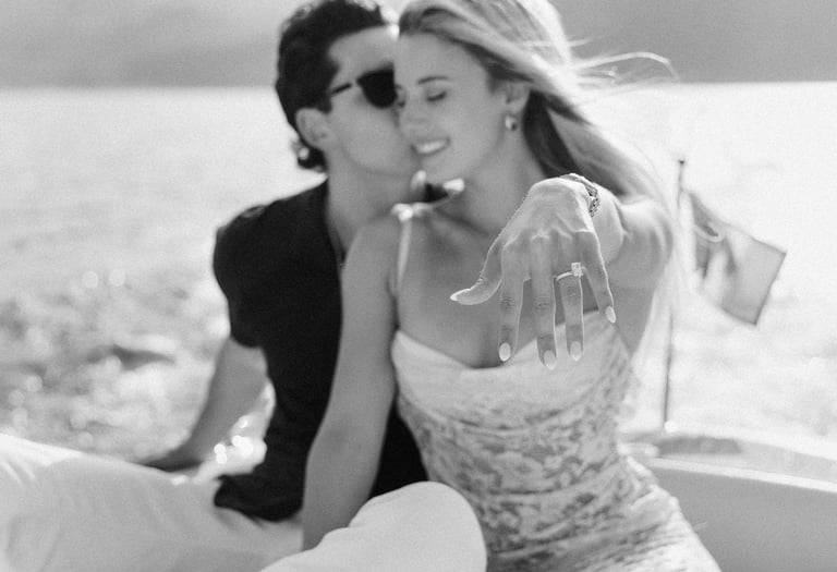 a man and woman kissing on a boat in Lake Como