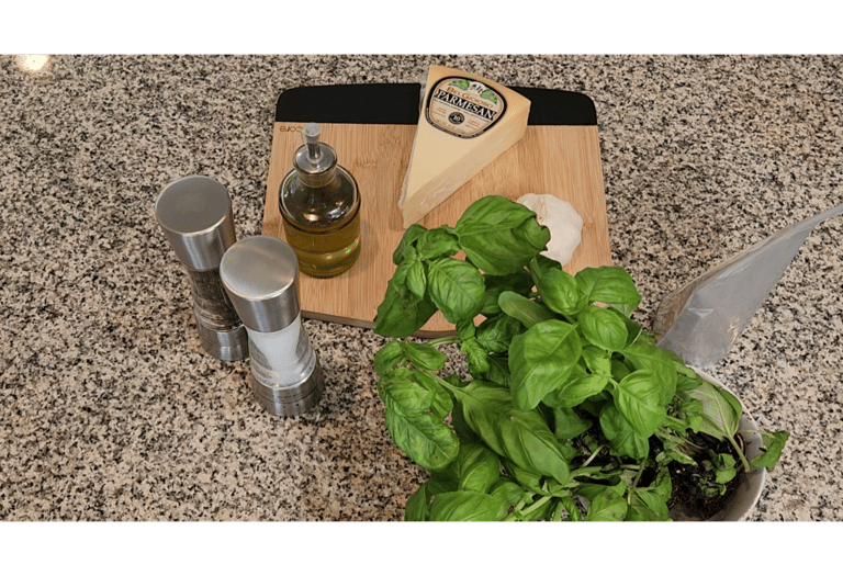 a cutting board on a counter with parmesan cheese, salt, pepper, allbaca olive oil and garlic