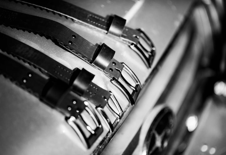 assortment of belts in black and white