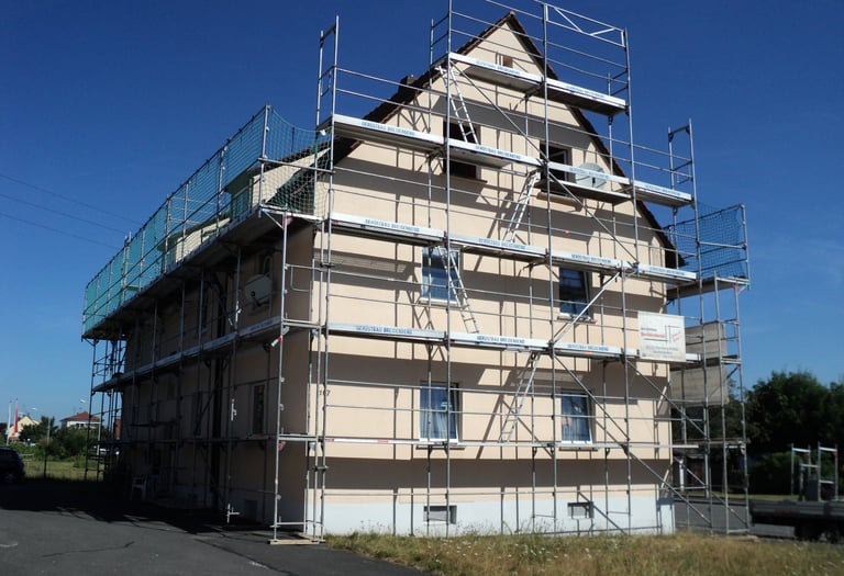 a house with scaffiered scaffolding on the side of a building